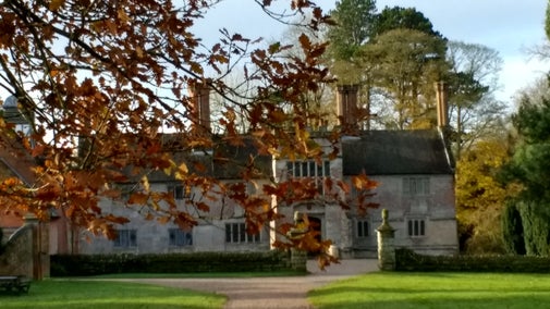 The house at Baddesley Clinton seen through autumn leaves